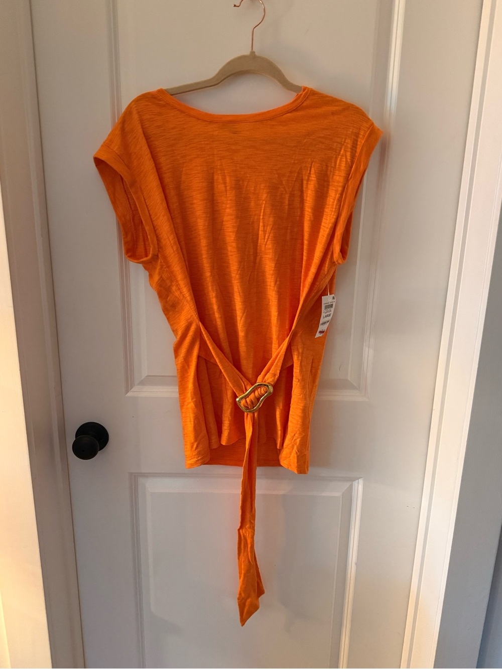 Bright top with a bright, cheerful orange top with a unique gold side tie